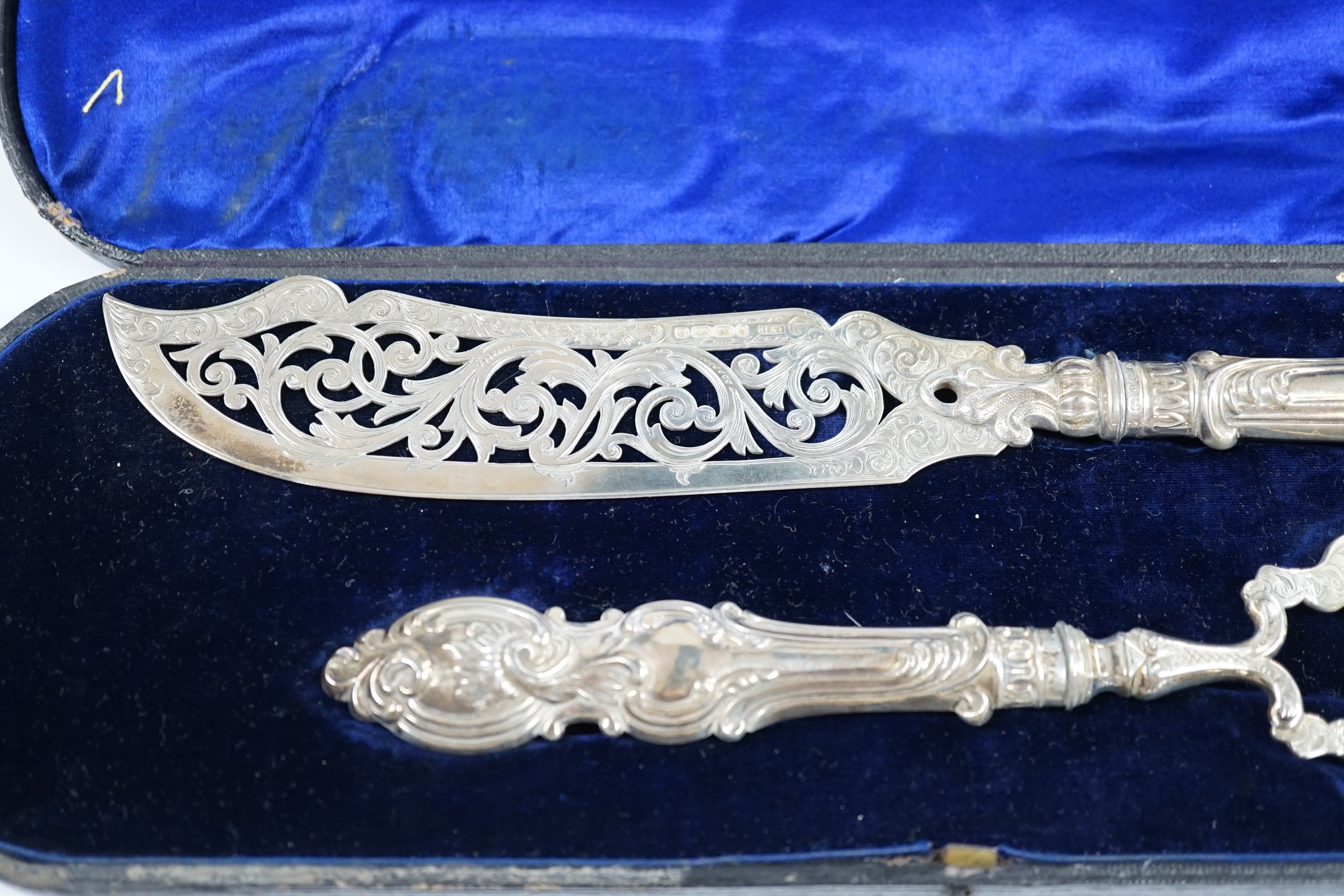 A cased pair of Victorian silver fish servers, maker H&I, Birmingham, 1863, knife 32.1cm. Condition - fair